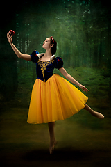 Image showing Young ballet dancer as a Snow White with poisoned apple in forest