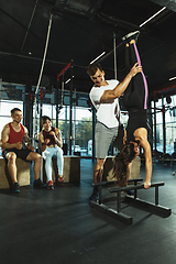 Image showing A group of muscular athletes doing workout at the gym