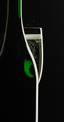 Image showing sparkling wine in dark back