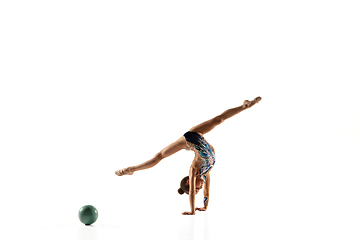 Image showing Little flexible female gymnast isolated on white studio background