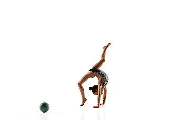 Image showing Little flexible female gymnast isolated on white studio background