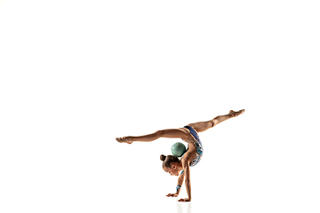 Image showing Little flexible female gymnast isolated on white studio background