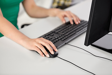 Image showing female hand with computer mouse on table