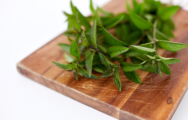 Image showing bunch of fresh peppermint on wooden cutting board