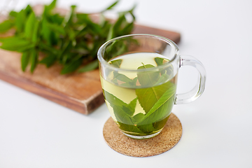 Image showing herbal tea with fresh peppermint on wooden board