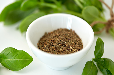 Image showing fresh basil and dry seasoning on white background