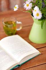 Image showing herbal tea, book and flowers in jug on table