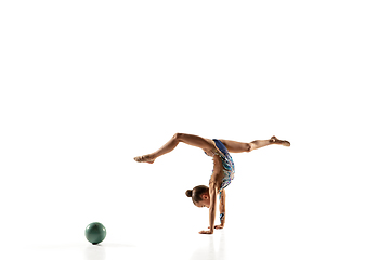 Image showing Little flexible female gymnast isolated on white studio background