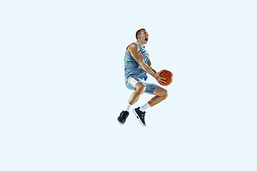 Image showing Young caucasian basketball player against white studio background