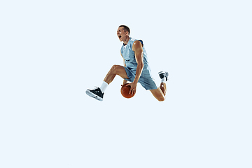 Image showing Young caucasian basketball player against white studio background