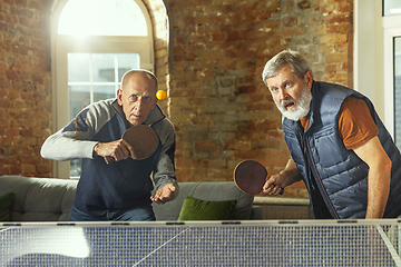 Image showing Senior men playing table tennis in workplace, having fun