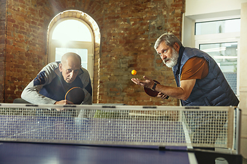 Image showing Senior men playing table tennis in workplace, having fun