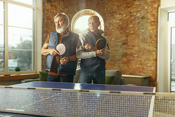 Image showing Senior men playing table tennis in workplace, having fun