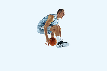 Image showing Young caucasian basketball player against white studio background