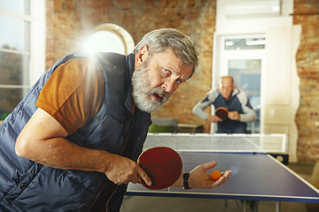 Image showing Senior men playing table tennis in workplace, having fun