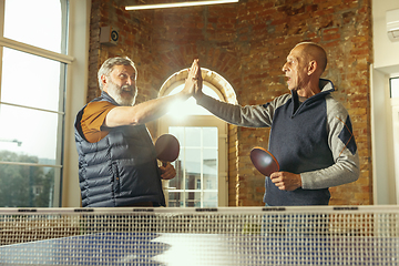 Image showing Senior men playing table tennis in workplace, having fun