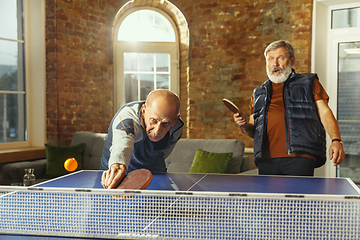 Image showing Senior men playing table tennis in workplace, having fun