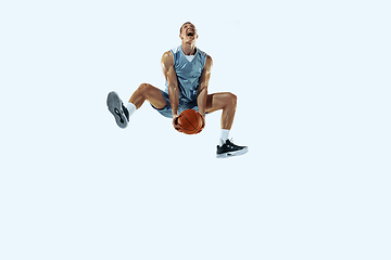 Image showing Young caucasian basketball player against white studio background