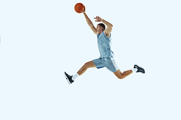 Image showing Young caucasian basketball player against white studio background