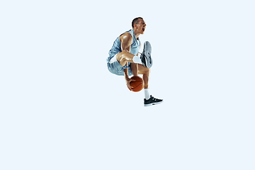 Image showing Young caucasian basketball player against white studio background