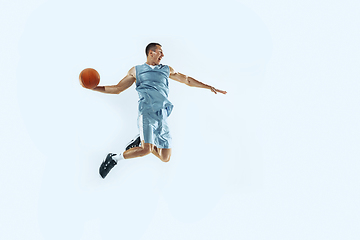 Image showing Young caucasian basketball player against white studio background