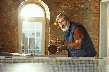 Image showing Senior man playing table tennis in workplace, having fun