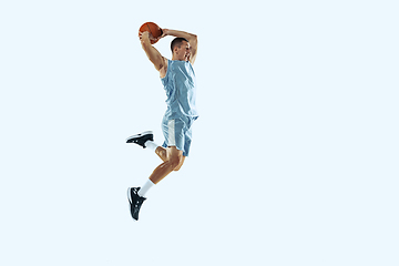 Image showing Young caucasian basketball player against white studio background