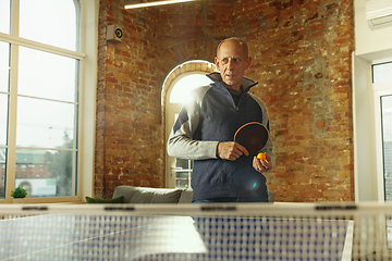 Image showing Senior man playing table tennis in workplace, having fun