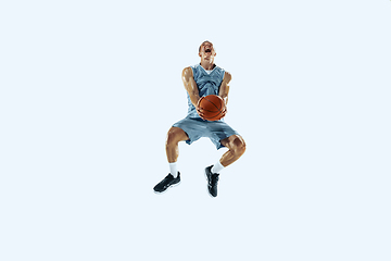 Image showing Young caucasian basketball player against white studio background