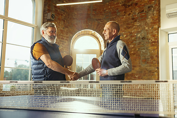 Image showing Senior men playing table tennis in workplace, having fun