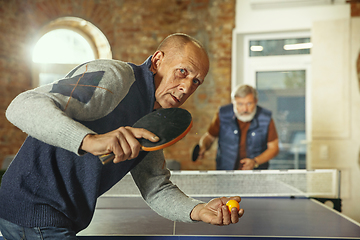 Image showing Senior men playing table tennis in workplace, having fun