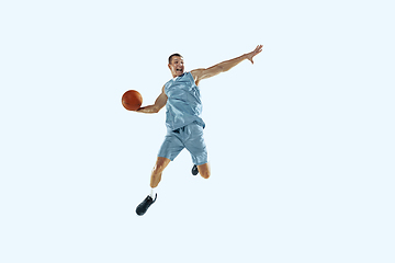 Image showing Young caucasian basketball player against white studio background