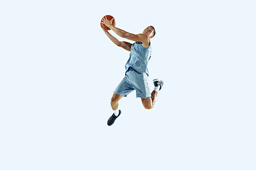 Image showing Young caucasian basketball player against white studio background