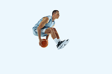 Image showing Young caucasian basketball player against white studio background