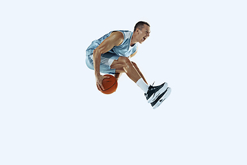 Image showing Young caucasian basketball player against white studio background