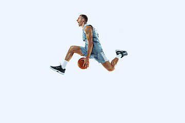 Image showing Young caucasian basketball player against white studio background