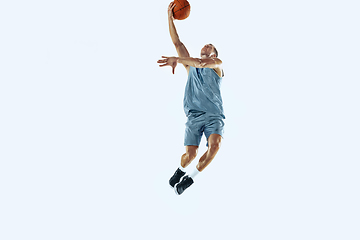 Image showing Young caucasian basketball player against white studio background