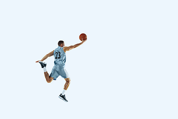 Image showing Young caucasian basketball player against white studio background