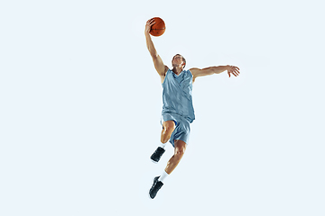 Image showing Young caucasian basketball player against white studio background