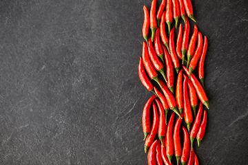 Image showing red chili or cayenne pepper on slate stone surface