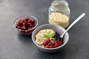 Image showing cereal breakfast with berries, banana and spoon