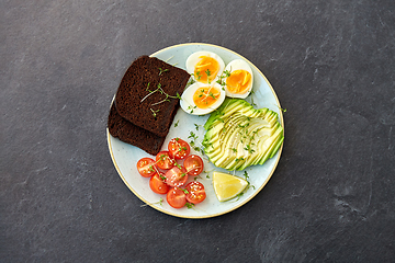 Image showing avocado, eggs, toast bread and cherry tomato