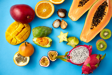 Image showing different exotic fruits on blue background