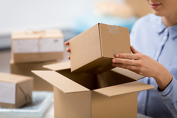 Image showing woman packing parcel box at post office