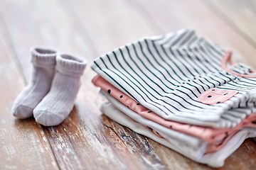 Image showing close up of baby clothes on wooden table