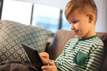 Image showing happy little boy with tablet computer at home