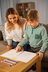 Image showing mother and son with pencils drawing at home