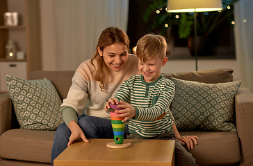 Image showing mother and son playing with toy pyramid at home