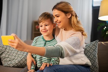 Image showing mother and son taking selfie by smartphone at home