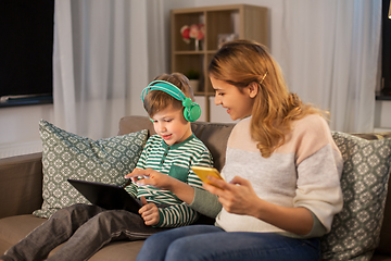 Image showing mother and son using gadgets at home